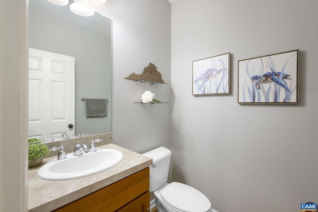 half bath with vanity and toilet