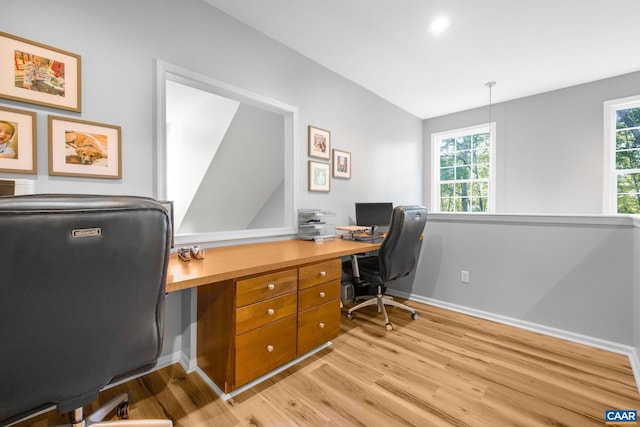 office with baseboards, plenty of natural light, light wood-type flooring, and lofted ceiling
