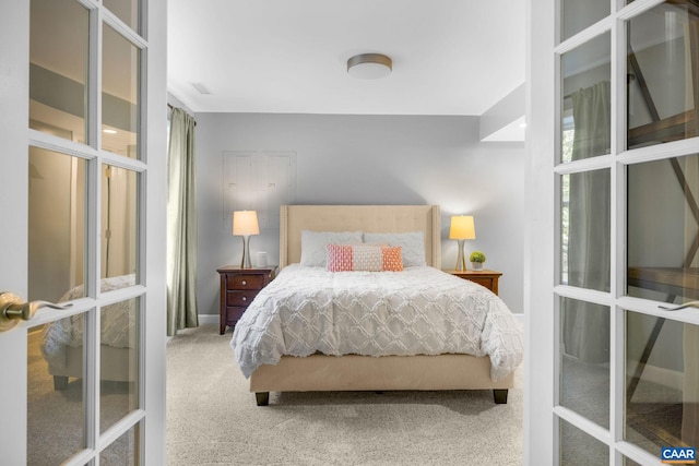 carpeted bedroom with baseboards and french doors
