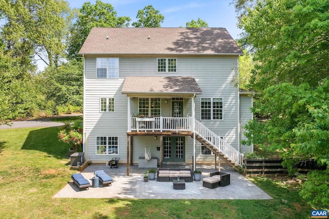 back of house featuring french doors, a lawn, a wooden deck, a patio, and outdoor lounge area