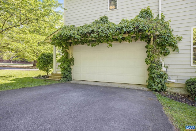 garage featuring aphalt driveway