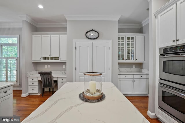 kitchen featuring double oven, dark wood-style floors, white cabinets, ornamental molding, and recessed lighting