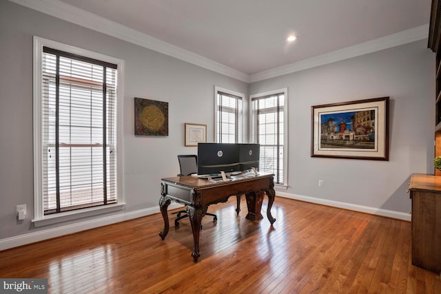office with hardwood / wood-style floors, plenty of natural light, baseboards, ornamental molding, and recessed lighting