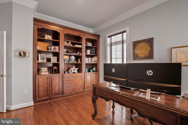 home office featuring wood finished floors, crown molding, and baseboards
