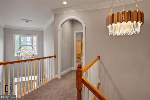 hall featuring a chandelier, carpet, ornamental molding, an upstairs landing, and baseboards