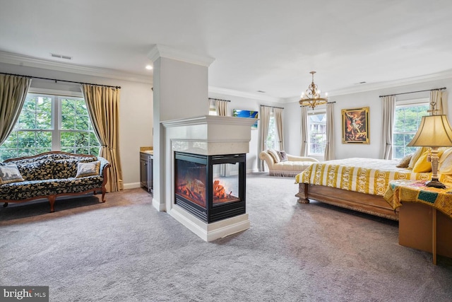 carpeted bedroom featuring ornamental molding, a chandelier, a multi sided fireplace, and recessed lighting