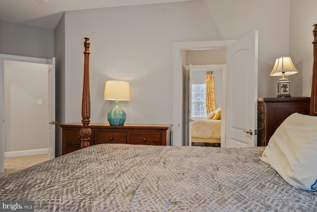 carpeted bedroom featuring baseboards