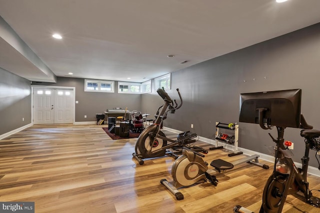 workout area featuring recessed lighting, baseboards, and wood finished floors