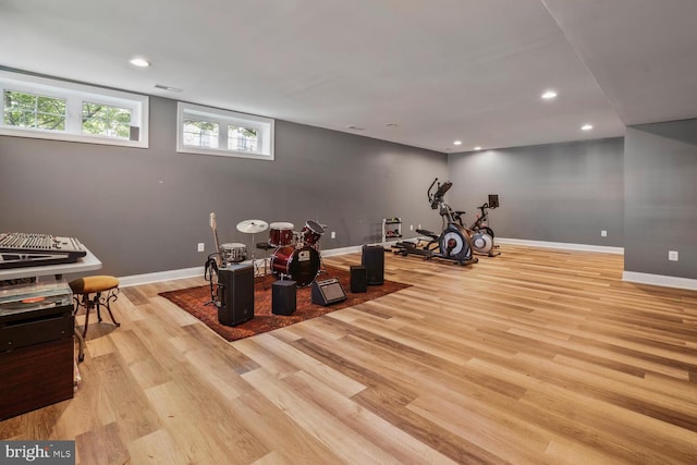 exercise room featuring light wood-style flooring, baseboards, and recessed lighting