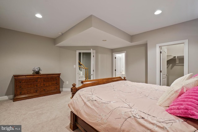 bedroom featuring carpet, baseboards, recessed lighting, and a walk in closet
