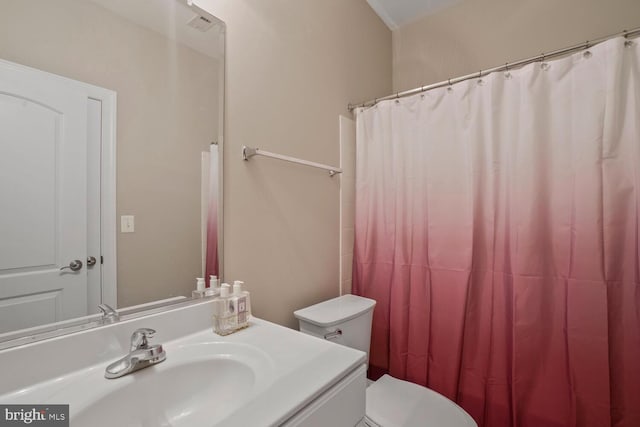 full bathroom with toilet, vanity, and a shower with curtain