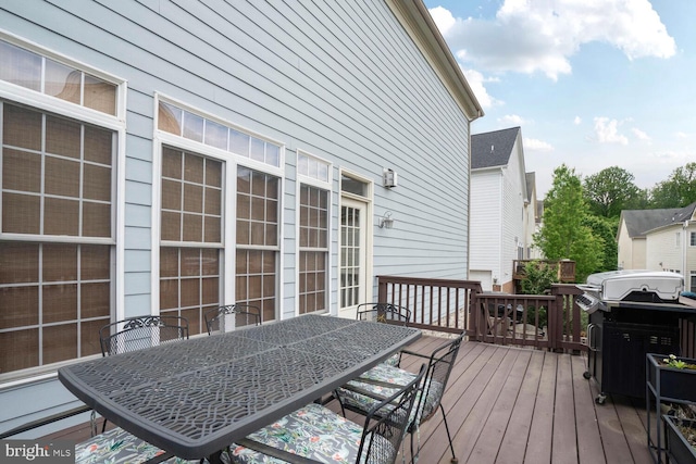 wooden deck featuring outdoor dining area and area for grilling