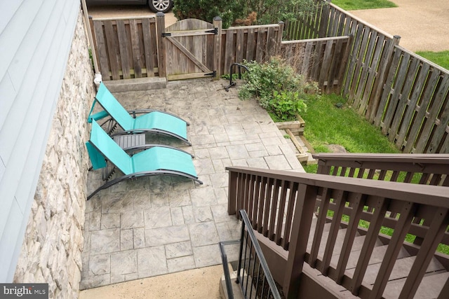 view of patio with a gate