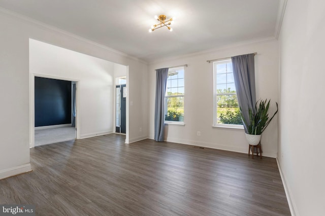 unfurnished room with baseboards, dark wood-style floors, and ornamental molding