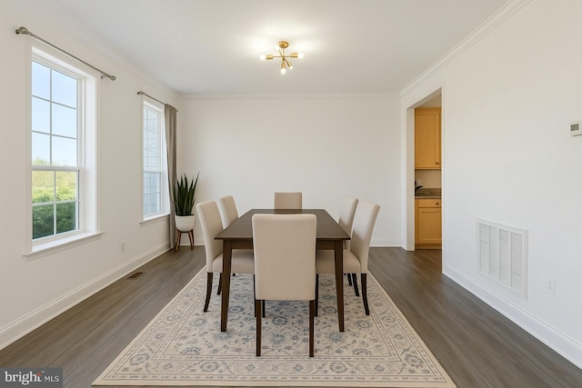 dining room with baseboards, ornamental molding, dark wood-style flooring, and visible vents