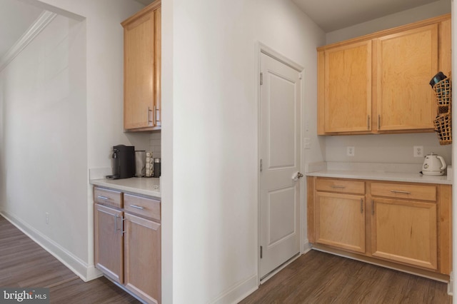 kitchen with light countertops, light brown cabinetry, baseboards, and dark wood-style flooring
