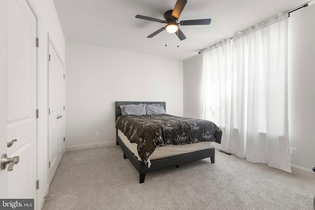 bedroom with baseboards, carpet, and a ceiling fan
