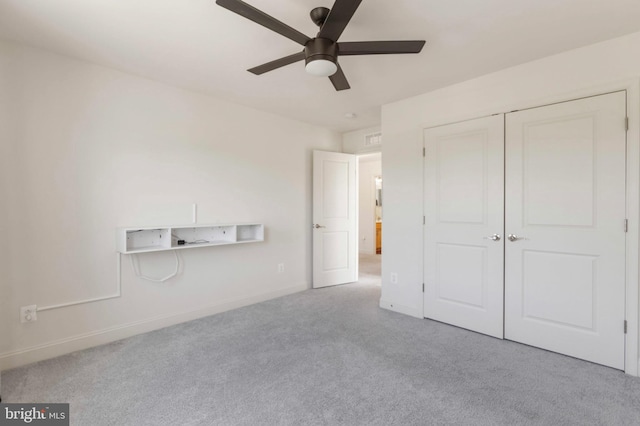 unfurnished bedroom with carpet floors, a ceiling fan, baseboards, and a closet
