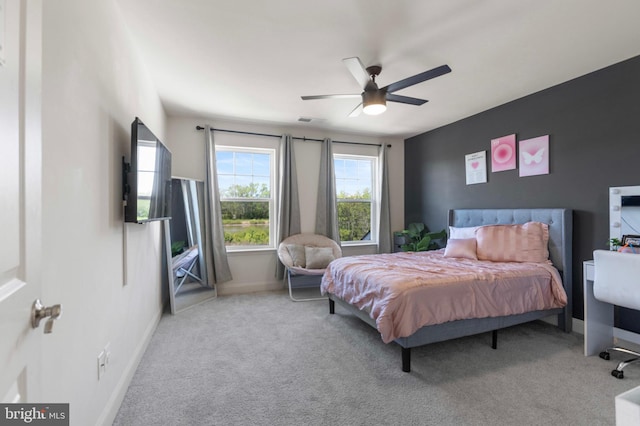 carpeted bedroom featuring visible vents, baseboards, and ceiling fan