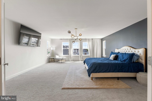 bedroom with baseboards and carpet