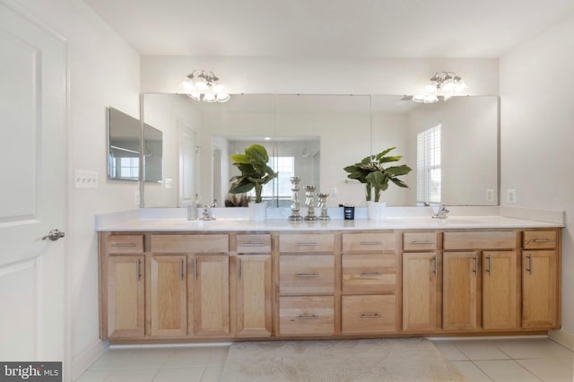 bathroom featuring double vanity, tile patterned floors, a sink, and a chandelier