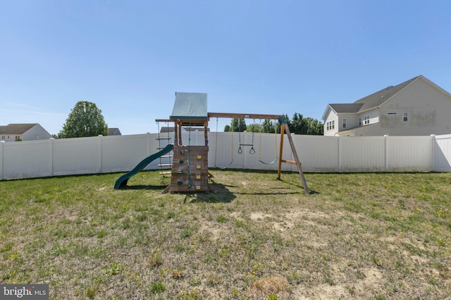 view of playground featuring a fenced backyard and a yard