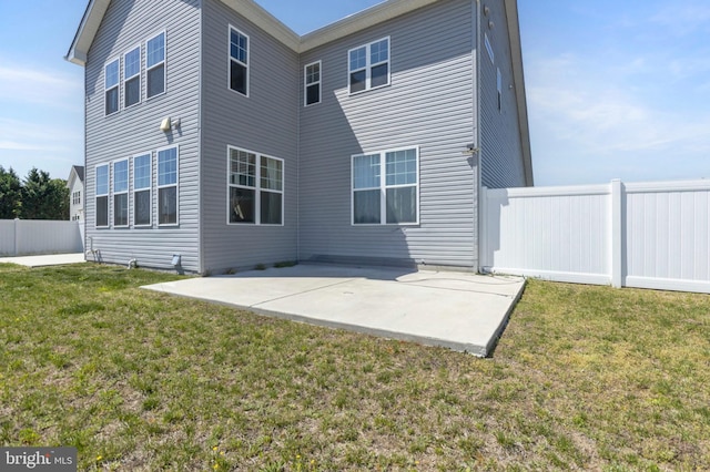 back of house with a lawn, fence, and a patio area