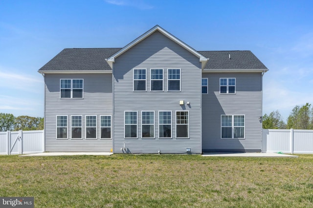 rear view of property with a yard, a fenced backyard, and a patio area