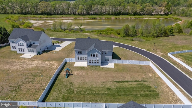 drone / aerial view with a water view and a forest view