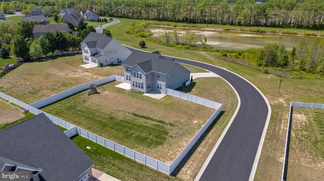 aerial view featuring a water view and a wooded view