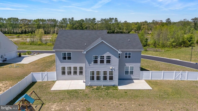 back of property with a gate, a patio area, a fenced backyard, and a yard