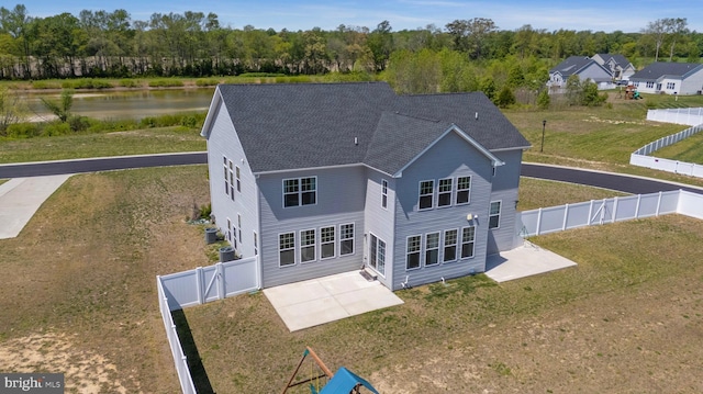 back of house with a yard, a patio, a shingled roof, and a gate