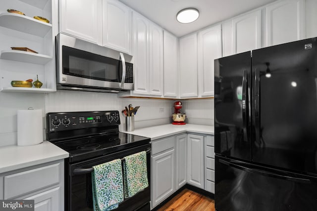 1826 Hylton Ave, Woodbridge, VA 22191 - kitchen featuring black appliances, light countertops, and white cabinetry
