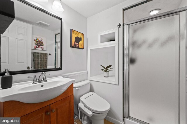 1826 Hylton Ave, Woodbridge, VA 22191 - bathroom featuring toilet, a stall shower, vanity, and a wainscoted wall