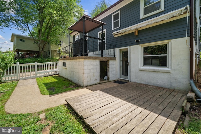 1826 Hylton Ave, Woodbridge, VA 22191 - rear view of house featuring a wooden deck, fence, and stucco siding