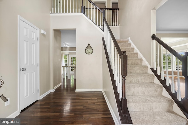 7883 Leroux Ln, Manassas, VA 20112 - stairway with wood finished floors, a high ceiling, and baseboards