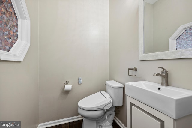 7883 Leroux Ln, Manassas, VA 20112 - bathroom featuring toilet, baseboards, vanity, and wood finished floors