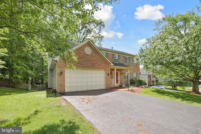 7883 Leroux Ln, Manassas, VA 20112 - colonial home with driveway, a garage, and brick siding
