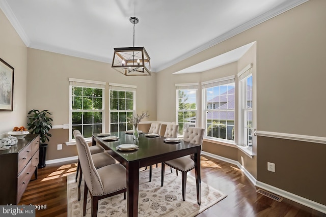 7883 Leroux Ln, Manassas, VA 20112 - dining room with a chandelier, crown molding, dark wood finished floors, and baseboards