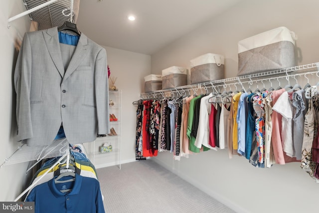 walk in closet with carpet flooring
