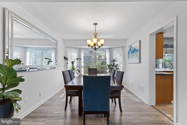 3565 Hummock Pl, Woodbridge, VA 22192 - dining space with a chandelier, light wood-style flooring, and baseboards