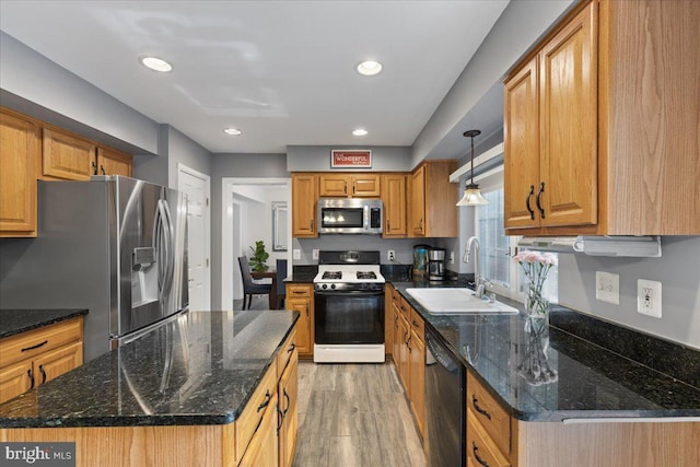 3565 Hummock Pl, Woodbridge, VA 22192 - kitchen with stainless steel appliances, a sink, light wood finished floors, recessed lighting, and a kitchen island