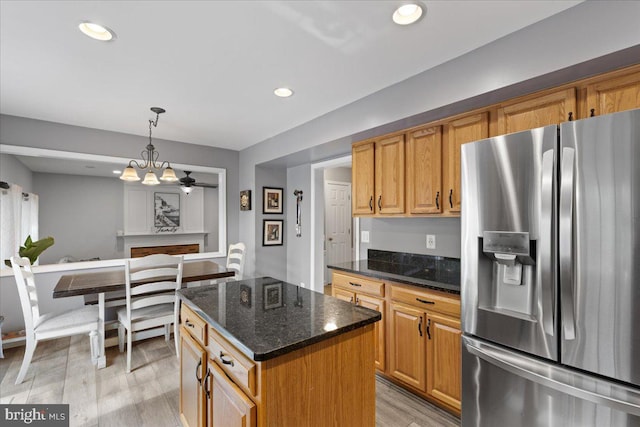 3565 Hummock Pl, Woodbridge, VA 22192 - kitchen with stainless steel refrigerator with ice dispenser, light wood-style floors, dark stone countertops, decorative light fixtures, and recessed lighting