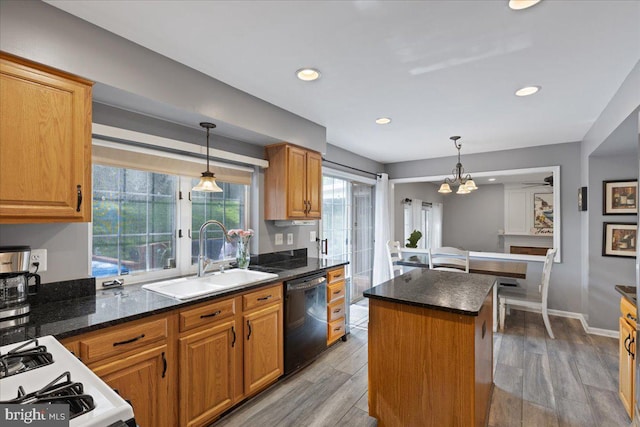 3565 Hummock Pl, Woodbridge, VA 22192 - kitchen featuring black dishwasher, a sink, a kitchen island, light wood-style flooring, and decorative light fixtures