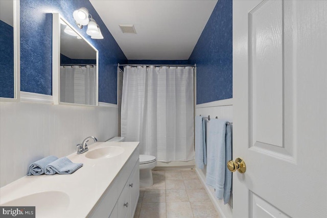 3565 Hummock Pl, Woodbridge, VA 22192 - bathroom featuring wainscoting, double vanity, a shower with shower curtain, toilet, and tile patterned floors