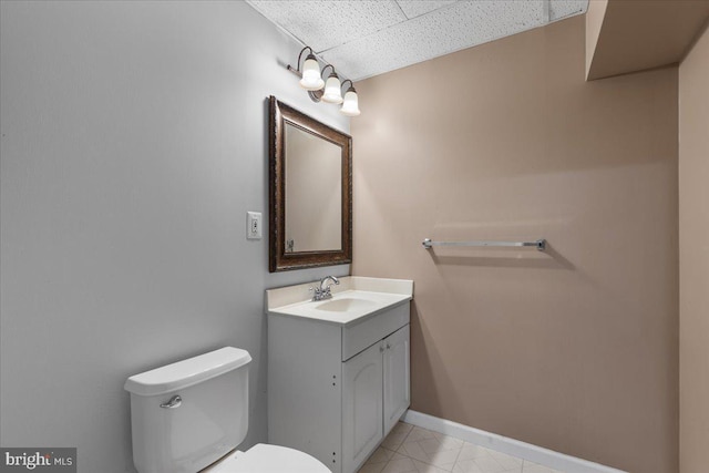 3565 Hummock Pl, Woodbridge, VA 22192 - half bath featuring a drop ceiling, toilet, baseboards, vanity, and tile patterned floors