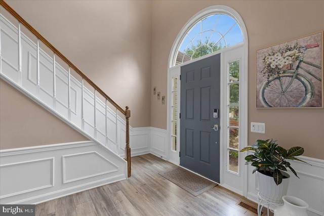 3565 Hummock Pl, Woodbridge, VA 22192 - entrance foyer featuring a decorative wall, wainscoting, wood finished floors, and stairs