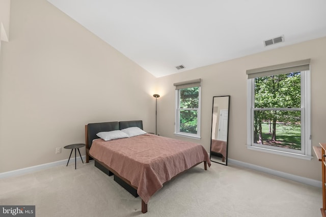 bedroom with baseboards, visible vents, and light carpet