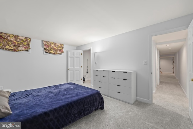 bedroom featuring baseboards and light carpet