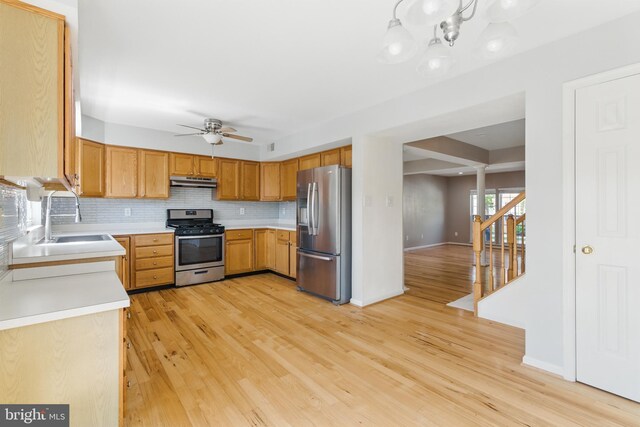 13014 Prairie Knoll Ct, Germantown, MD 20874 - kitchen featuring under cabinet range hood, light countertops, a sink, appliances with stainless steel finishes, and ceiling fan with notable chandelier